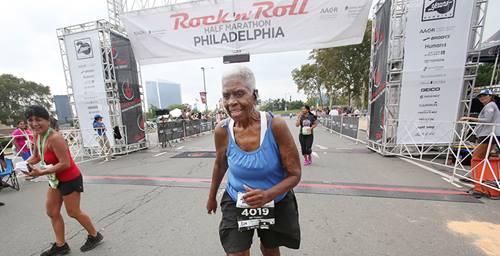 Lorraine Cephus crossing the Philly half marathon line