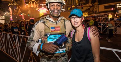 Two runners, one with the military wearing his Army gear