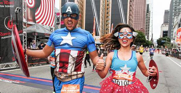two runners dressed as superheros