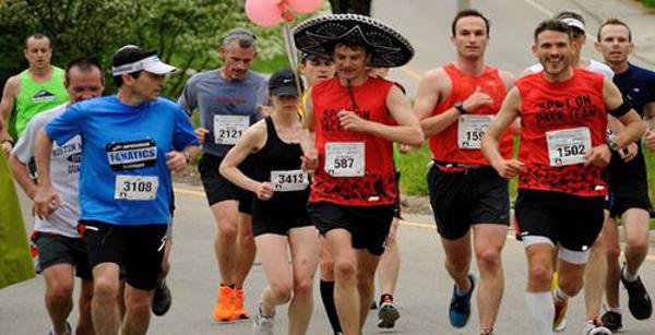a group of runners, one wearing a sombrero
