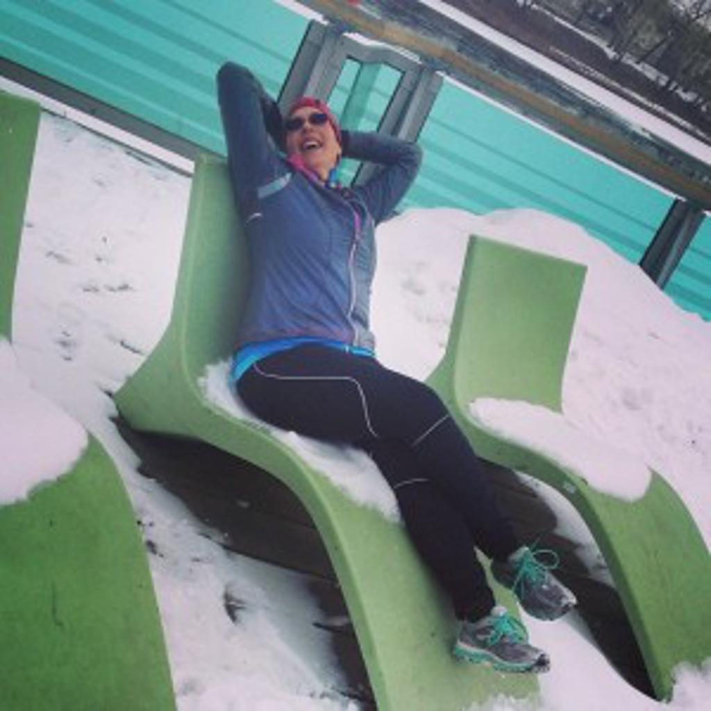runner laying on a lawnchair in winter