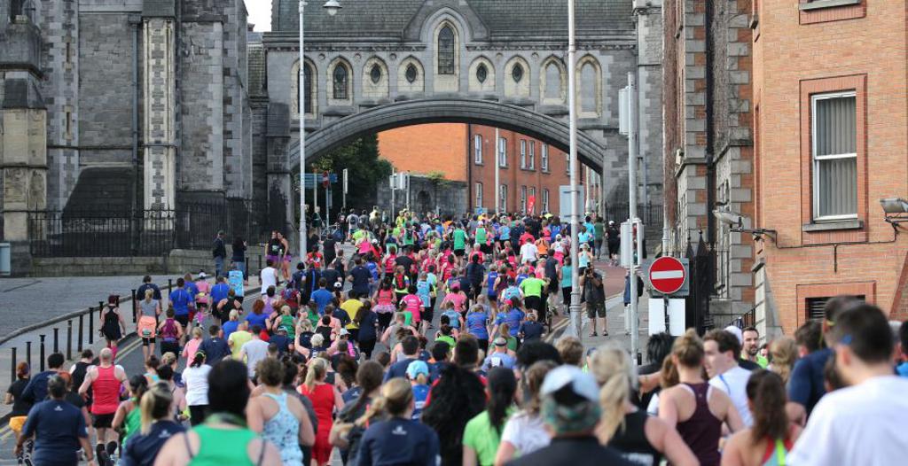 Runners in Dublin under a church like structure